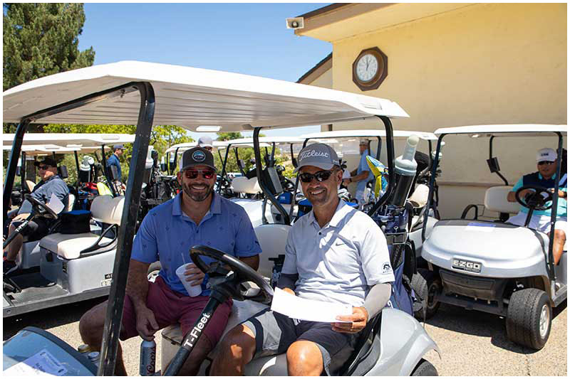 Two gentlemen in a golf cart